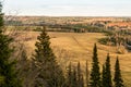 View from the top of the hill to fields, groves, winding road and tops of fir trees in early spring Royalty Free Stock Photo