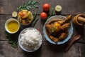 View from top of Indian food or meal with potato fry,chicken curry rice, lentils, papad and condiments. Royalty Free Stock Photo