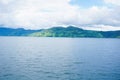 View from the top of Lake Toba hill with views of the hills and beautiful blue lake water Royalty Free Stock Photo