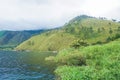 view from the top of Lake Toba hill with views of the hills and beautiful blue lake water Royalty Free Stock Photo