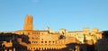 View of the top of the leaning Torre delle Milizie above a section of Mercati di Traiano in Rome, golden in the sunset