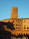 View of the top of the leaning Torre delle Milizie with a section of Mercati di Traiano in Rome, golden in the sunset