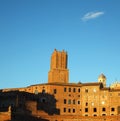 View of the top of the leaning Torre delle Milizie with a section of Mercati di Traiano in Rome, golden in the sunset