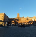 View of the top of the leaning Torre delle Milizie with a section of Mercati di Traiano in Rome, lit by the golden glow of the set