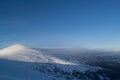 View of the top of the mountain covered with snow-covered firs