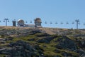 View at the top of the mountains of the Serra da Estrela natural park, tower buildings with dome and cable car railway circuit, Royalty Free Stock Photo