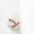 View from top painter man at work with a paint roller, wall pain Royalty Free Stock Photo