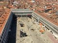 A view from the top of St Marks Campanile of St Marks Square looking down on the square with tourists below and the amazing city