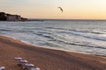 View from the top to the sea coast with a sandy beach and a seagull flying over the sea at dawn. Black Sea, Bulgaria