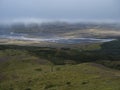 View from top of Valahnukur mountain on landscape of green valley of Thorsmork with volcano huts camp site, sharp green