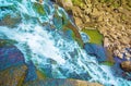 View from the top of the waterfall falling down, forest landscape with a waterfall, where begins the descent to water.