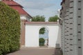 View of the topiary and the sea through the doorway in the white wall. Hidden park. Secret garden.