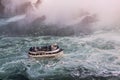 View of tourist boat on rumbling waves of Niagara falls.  Tourism concept. Royalty Free Stock Photo