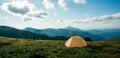 View of tourist tent in mountains at sunrise or sunset. Camping background. Adventure travel active lifestyle freedom concept.