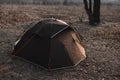 View of a tourist tent with a quick-build system, brown. no people. place for text. Dull dark tones of autumn morning, winter Royalty Free Stock Photo