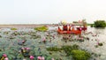 Tourists enjoying a morning boat ride in Red Lotus Lake, Kumphawapi,Talay Bua Daeng, Udon Thani, Thailand