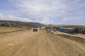 View of tourists off-road cars on sandy desert road merging with pale blue sky on horizon. Royalty Free Stock Photo