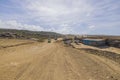 View of tourists off-road cars on sandy desert road merging with pale blue sky on horizon. Royalty Free Stock Photo