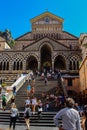 View of tourists on the streets of Amalfi, who stop to admire the cathedral Royalty Free Stock Photo