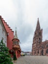 View of tourists visiting the cathedral and minster in Freiburg in the Breisgau