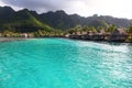 View towards the a bay in Moorea, with turquoise tropical water & bungalows over the sea. French Polynesia, South Pacific Royalty Free Stock Photo