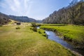 A view towards the castle ruins down the floodplain of Pennard Pill stream that flows out to Three Cliffs Bay, South Wales Royalty Free Stock Photo