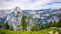 View towards Half Dome; Vernal Fall, Nevada Fall and Liberty Dome visible on the right; snow capped mountains in the background;