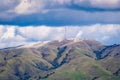 View towards Monument Peak on a cold winter day; some snow still present on the ground; storm clouds covering the sky; south San