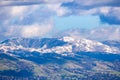 View towards Mt Hamilton and the Lick Observatory building on a sunny winter day; green hills in the foreground and snow covered Royalty Free Stock Photo