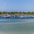 A view towards sailboats moored at low tide on the River Hamble