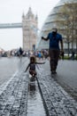 Tower Bridge in the background, taken at More London on the south bank. In the foreground is a blurred child playing in water Royalty Free Stock Photo