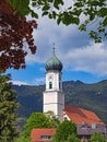 View of the tower of the Catholic parish church of St. Peter and Paul in Oberammergau, Bavaria, Germany Royalty Free Stock Photo