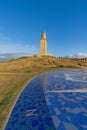 View of the Tower of Hercules in the city of A Coruna, Galicia, with tourists around it.