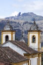 View of towers of historic baroque church Igreja Nossa Senhora das Merces e Perdoes, and mountains, Ouro Preto, Minas Gerais, Royalty Free Stock Photo