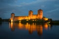 View of the towers of the Olavinlinna fortress in the august twilight. Savonlinna Royalty Free Stock Photo