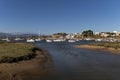 View of the town of Alvor with the white buildings and church and boat in the port, in Algarve, Portugal