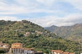 View of the town on the slope of the mountains, town by the sea in Italy, buildings located on the hills