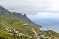 View of the town of Taganana in the north of Tenerife. Mountain green landscape with many small white houses on the ocean coast. Royalty Free Stock Photo