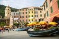 View of the town of Vernazza, with the colourful houses, the church and the old boats.