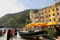 View of the town of Vernazza, with the colourful houses, the church and the old boats.