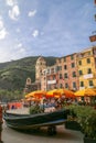 View of the town of Vernazza, with the colourful houses, the church and the old boats.