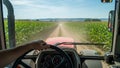 View from a Tractor Cab Driving Through a Cornfield Royalty Free Stock Photo