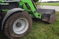 View of tractor front wheel and front end loader