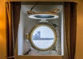 A view of a traditional antique circular window on a ship