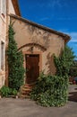 View of traditional colorful house in ocher and bindweed under a sunny blue sky, in Roussillon Royalty Free Stock Photo