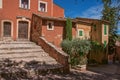 View of traditional colorful house in ocher and staircase, in Roussillon.