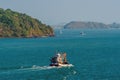 A view of traditional fishing boats heading out to sea of the island of Phuket, Thailand Royalty Free Stock Photo