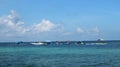 view of traditional fishing boats leaning on the beach with very clear sea water and blue sky Royalty Free Stock Photo