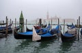 View of traditional Gondolas on Canal Grande in Venice Venezia in a foggy day with San Giorgio Island on the background, Italy Royalty Free Stock Photo