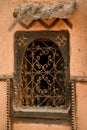 Traditional Moroccan window with ornaments in a clay house, Arabic architectural detail